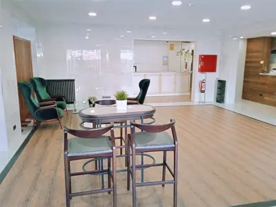 a dining room with a table and chairs in a room at Hotel 153 in Castelldefels