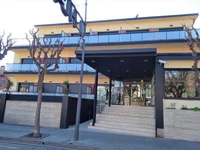 a street sign in front of a building at Hotel 153 in Castelldefels