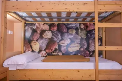 a bunk bed with a mural on the wall at Inout in Barcelona