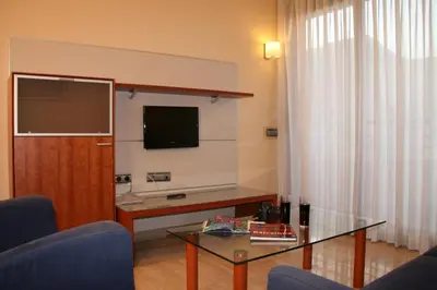 a living room with a tv and a glass table at Apartaments Aragó565 in Barcelona