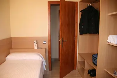 a small room with a bed and a closet at Apartaments Aragó565 in Barcelona