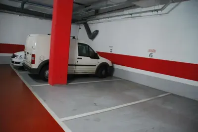 a white van parked in a parking garage at Apartaments Aragó565 in Barcelona