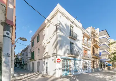 a white building on the side of a street at Vistamar 2: Primera línea de mar con gran terraza in Sitges