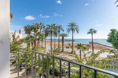 a view of the beach from a balcony at Vistamar 2: Primera línea de mar con gran terraza in Sitges