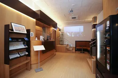 a large room with a projection screen in a building at Hotel Esplugues in Esplugues de Llobregat
