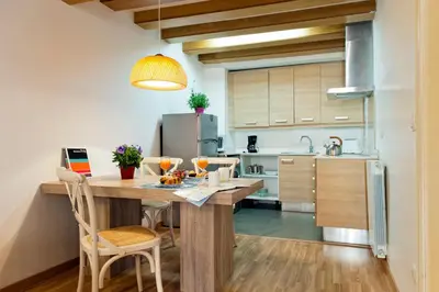 a kitchen with a large wooden table and chairs at MH Apartments Liceo in Barcelona