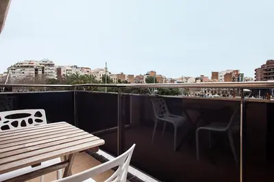 a building under construction with chairs in front of it at Suites4days Provenza Apartment in Barcelona