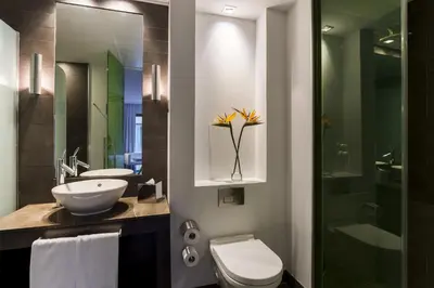 a bathroom with a sink and a toilet and a shower at Room Mate Carla, Barcelona in Barcelona