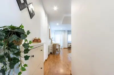a kitchen and dining room with white walls and a plant at Fantástico loft cerca centro by Lofties in Terrassa