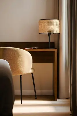 a desk with a lamp and a chair in a room at Hotel Hamsa House in Barcelona