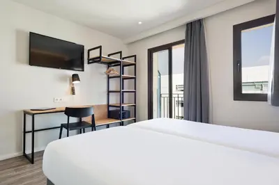 a hotel room with a bed and a desk at Acta BCN 40 in Barcelona