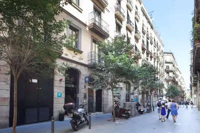 a group of people walking down a street next to a building at Acta BCN 40 in Barcelona