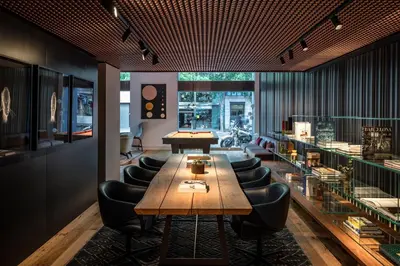 a living room with a couch and a table with books at Sir Victor Hotel, part of Sircle Collection in Barcelona