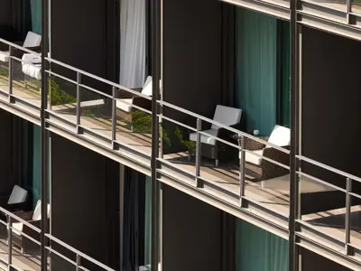a living room with two chairs and a table at Sofitel Barcelona Skipper in Barcelona