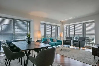a living room with a couch and a table and chairs at Alcam Llum Deluxe in Barcelona