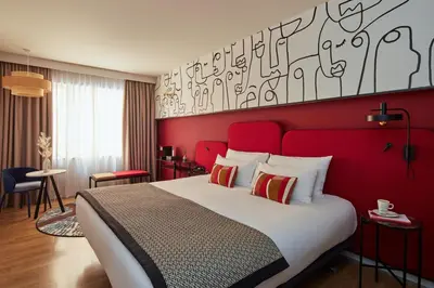 a bedroom with a red headboard and a red wall at Hotel Indigo Barcelona Plaza Espana by IHG in Barcelona