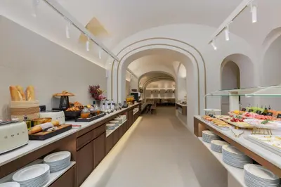 a large kitchen with a buffet line with food at Hotel Medinaceli 4 Estrellas SUPERIOR in Barcelona