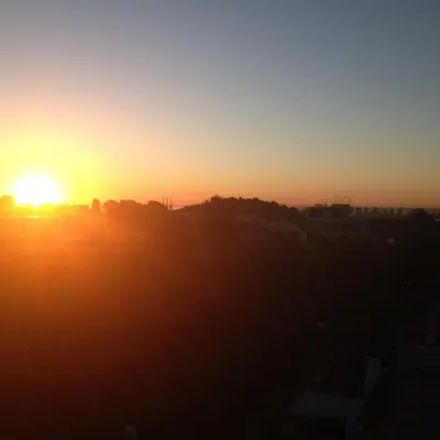 an image of the sun setting over a city at Colors in Barcelona