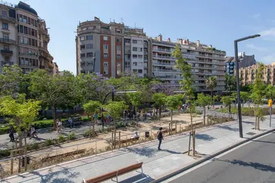 a park with trees and benches in a city at Apartments Sata Park Guell Area in Barcelona