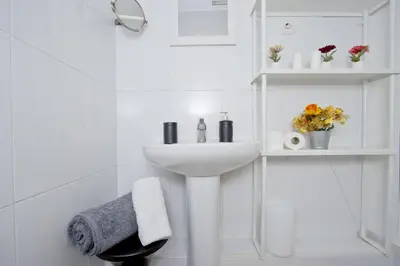 a white bathroom with a sink and a mirror at Barcelona City North Hostal in Barcelona