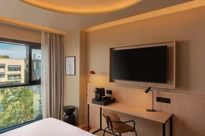 a hotel room with a flat screen tv on the wall at Four Points by Sheraton Barcelona Diagonal in Barcelona