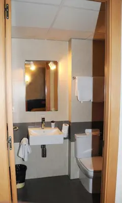 a bathroom with a sink and a toilet at Llagotel in La Llagosta