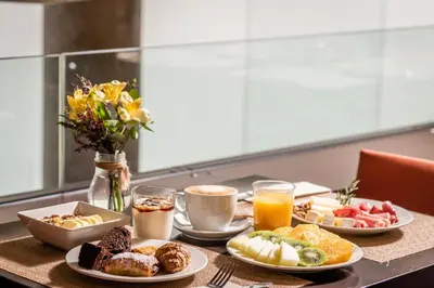 a table topped with plates of breakfast foods and drinks at Hotel Madanis in Barcelona