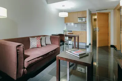 a living room with a couch and a table at Hesperia Fira in Hospitalet de Llobregat