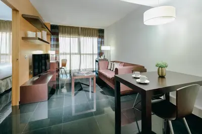 a living room with a couch and a table at Hesperia Fira in Hospitalet de Llobregat