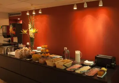 a buffet of food on a counter in a restaurant at Residència Erasmus Gracia in Barcelona