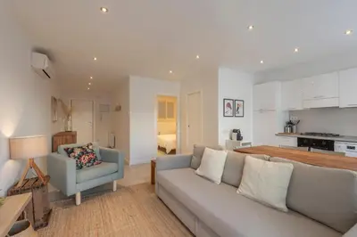 a living room with a couch and a kitchen at Mare Nostrum: En el corazón de Sitges in Sitges