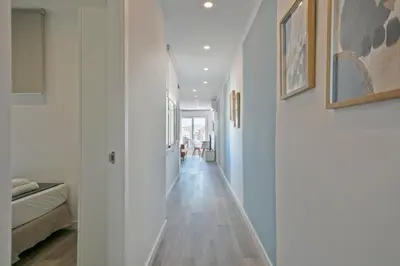 a hallway of a house with white walls and wooden floors at Alcam Badalona Roger in Badalona