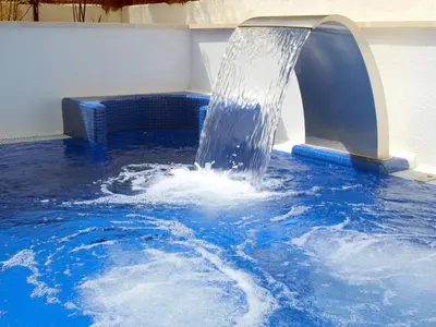 a water fountain in a swimming pool at Platjador in Sitges