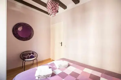 a bedroom with a purple bed and a chair at Consell Cent apartment I 3 dormitorios Eixample in Barcelona