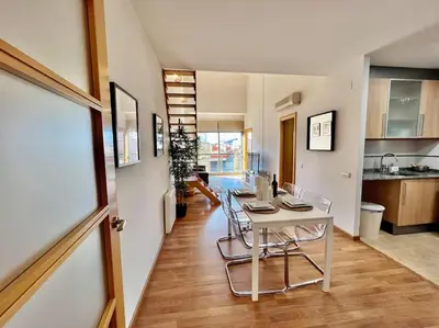 a kitchen with a table and chairs in a room at Apartamento espacioso y familiar in Terrassa