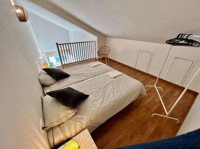 a bedroom with a large bed with pillows on it at Apartamento espacioso y familiar in Terrassa