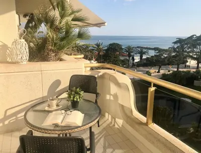a table and chairs on a balcony with the ocean at Mediterraneo Sitges in Sitges