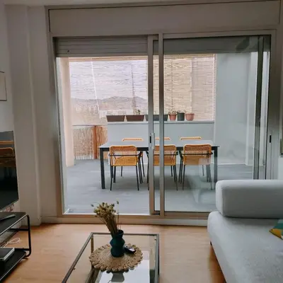 a living room with a couch and a table at Large terrace luxury apartment in Sant Adria de Besos