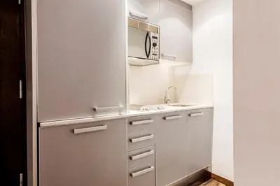 a small kitchen with a sink and a microwave at Barcelona Apartment Aramunt in Barcelona