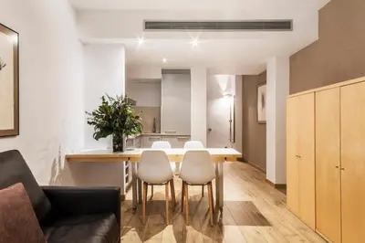 a kitchen and dining room with a table and chairs at Barcelona Apartment Aramunt in Barcelona
