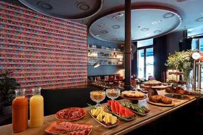 a table with plates of food and drinks on it at Chic & Basic Born Boutique Hotel in Barcelona