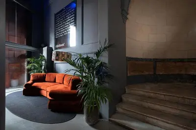 a living room with a couch and a plant at Chic & Basic Born Boutique Hotel in Barcelona