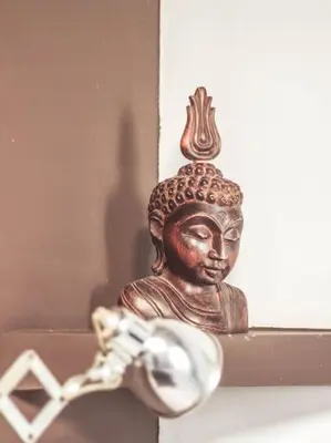 a bronze statue of a buddha on a shelf at MODERN FLAT POBLE NOU in Barcelona