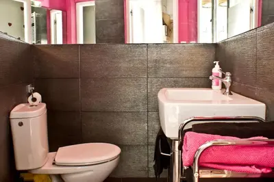 a bathroom with a white toilet and a sink at MODERN FLAT POBLE NOU in Barcelona