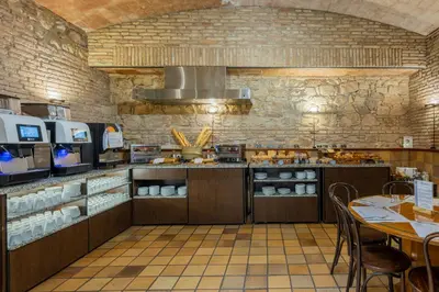 a large kitchen with a table and a stove at Hotel Rialto in Barcelona