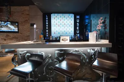 a bar with black leather chairs and a counter at Petit Palace Museum in Barcelona