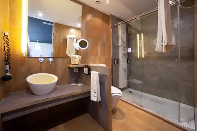 a bathroom with a sink and a toilet and a shower at Petit Palace Museum in Barcelona