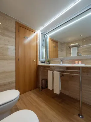 a bathroom with a toilet and a sink and a mirror at Vilana Hotel Boutique in Barcelona