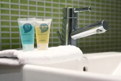 a bathroom sink with two bottles of moisturizing moisturizers on it at Onix Liceo in Barcelona