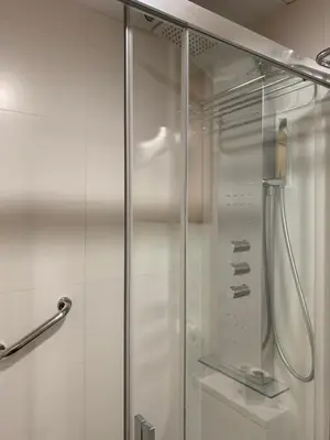 a shower with a glass door in a bathroom at Galeón in Sitges
